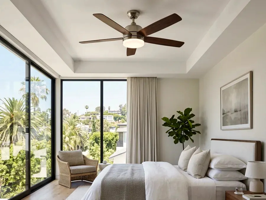 Hands installing a new grounded outlet into a wall box in an older Studio City home